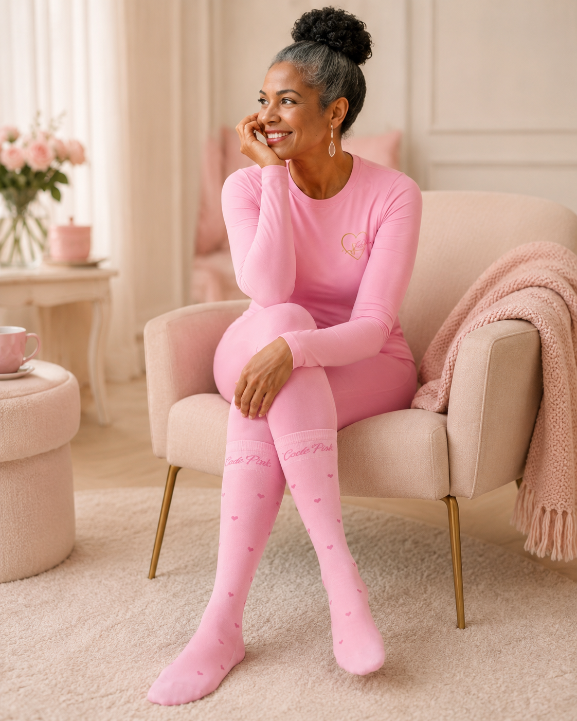Woman in the Code Pink Comfort Cloud Set relaxing in a pink armchair